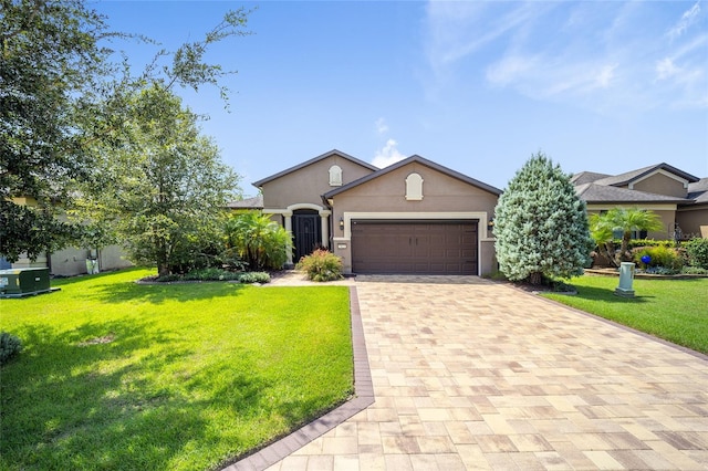 view of front facade with a garage and a front lawn