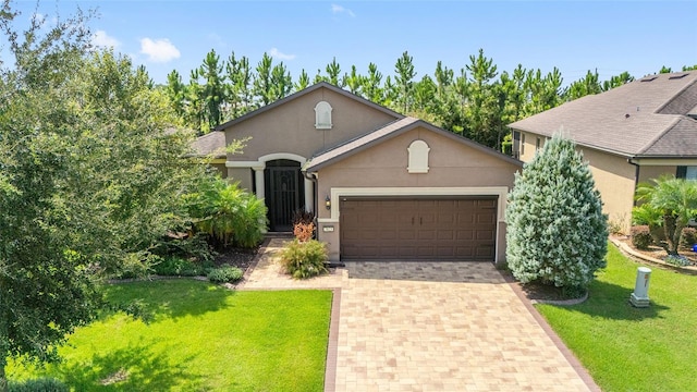 single story home with a garage and a front yard