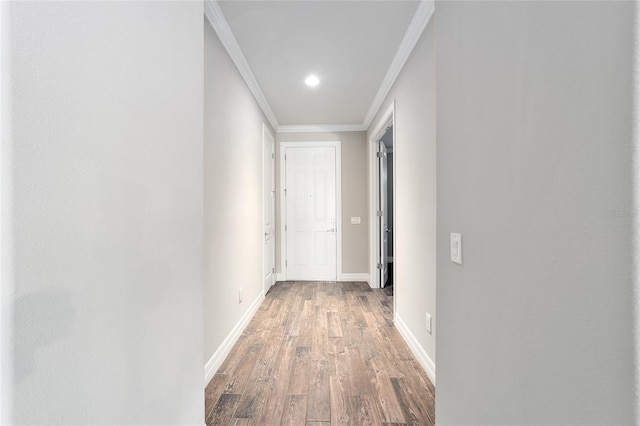 hall with hardwood / wood-style flooring and ornamental molding