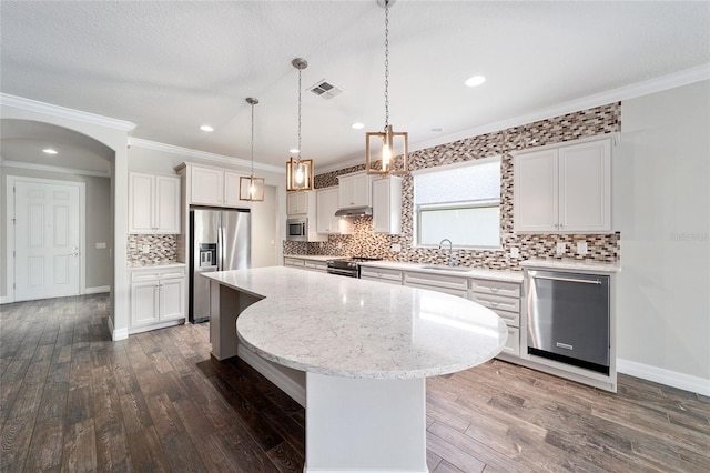 kitchen with a center island, white cabinets, sink, appliances with stainless steel finishes, and dark hardwood / wood-style flooring