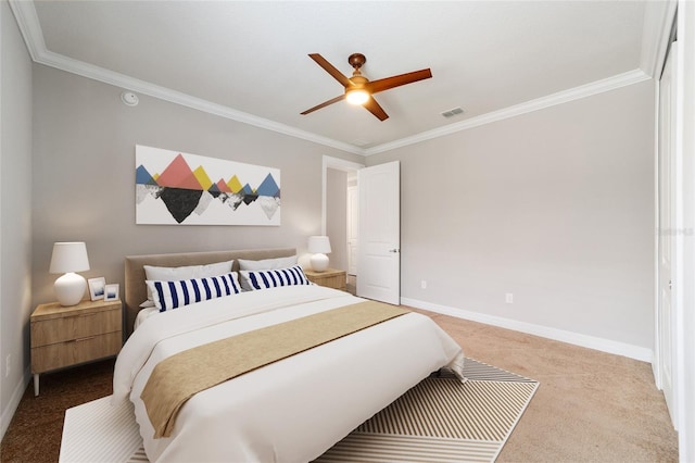 carpeted bedroom with ceiling fan and ornamental molding