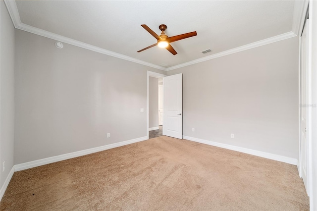 unfurnished room featuring carpet and crown molding