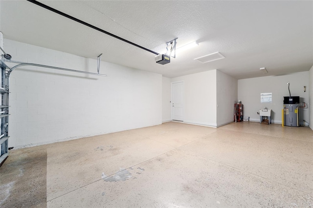 garage with electric water heater, sink, and a garage door opener