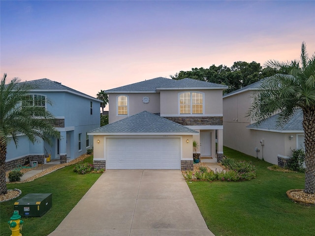 view of front facade featuring a yard and a garage