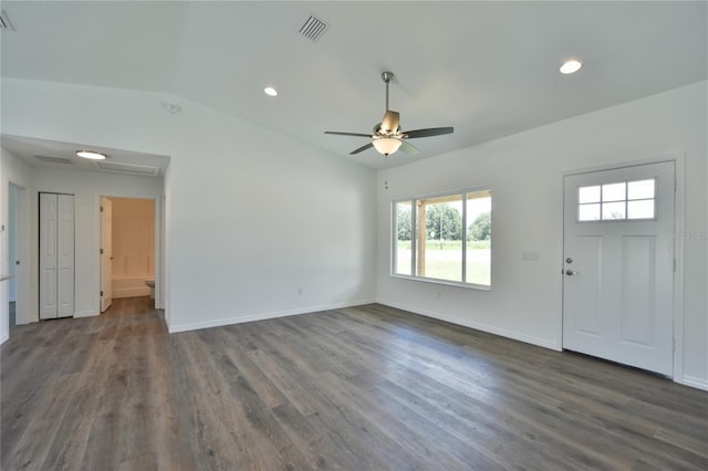 foyer entrance featuring dark wood-type flooring, vaulted ceiling, and ceiling fan