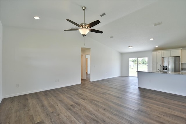 unfurnished living room featuring dark hardwood / wood-style flooring, high vaulted ceiling, and ceiling fan