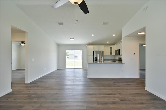 unfurnished living room featuring wood-type flooring, sink, and ceiling fan