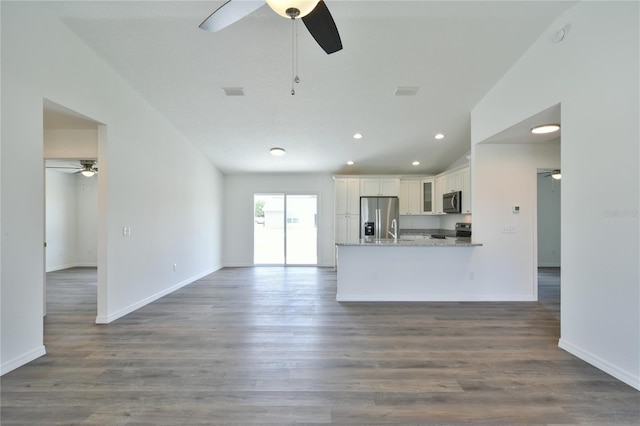 unfurnished living room with ceiling fan, wood-type flooring, and sink