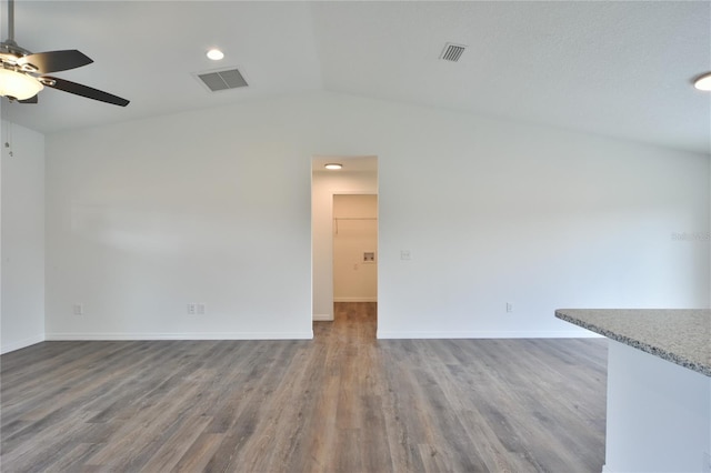 unfurnished living room featuring lofted ceiling, hardwood / wood-style floors, and ceiling fan