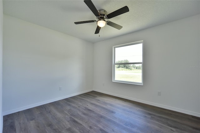 empty room with ceiling fan and dark hardwood / wood-style floors