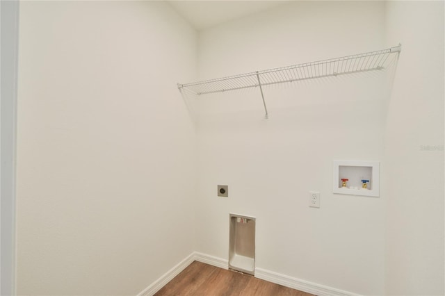 clothes washing area with hookup for a washing machine, hookup for an electric dryer, and wood-type flooring