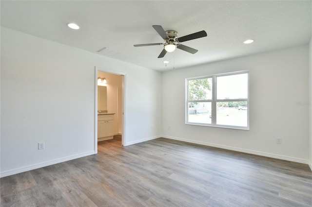 empty room featuring hardwood / wood-style floors and ceiling fan