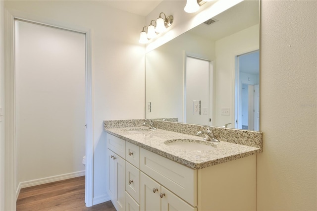 bathroom featuring toilet, hardwood / wood-style flooring, and vanity