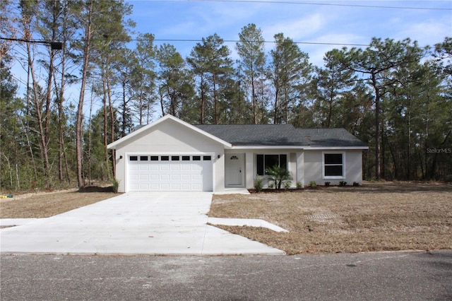 ranch-style home featuring a garage, concrete driveway, and stucco siding