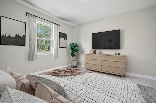 bedroom featuring baseboards and wood finished floors