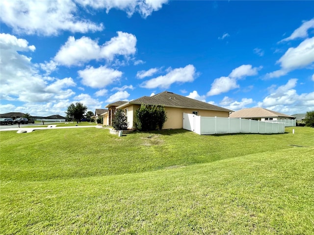 view of side of home featuring a yard