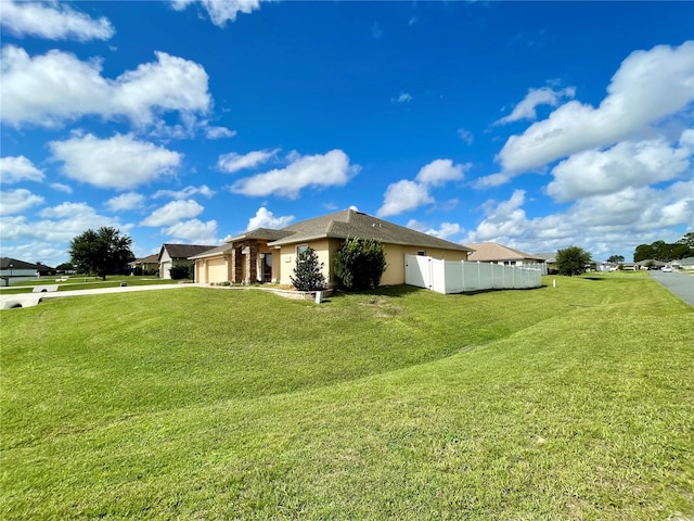 view of side of home featuring a garage and a yard