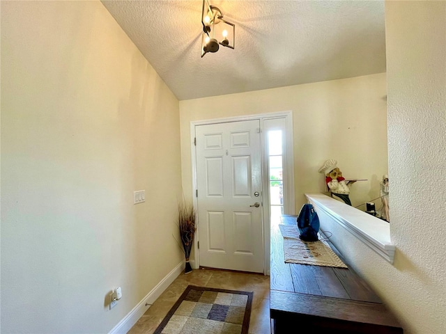 foyer with a textured ceiling