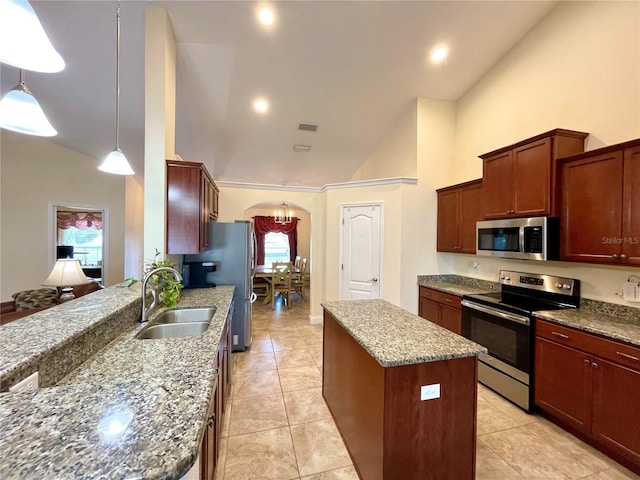 kitchen featuring a center island, light stone counters, stainless steel appliances, high vaulted ceiling, and pendant lighting