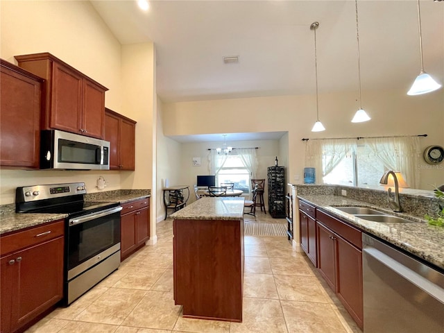 kitchen with a healthy amount of sunlight, stainless steel appliances, sink, and a center island