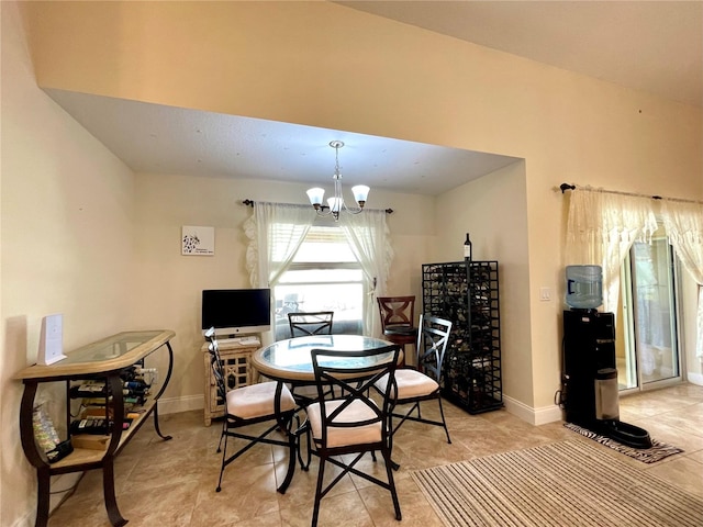 tiled dining space with a chandelier