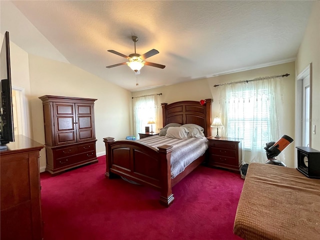 carpeted bedroom featuring vaulted ceiling, a textured ceiling, and ceiling fan