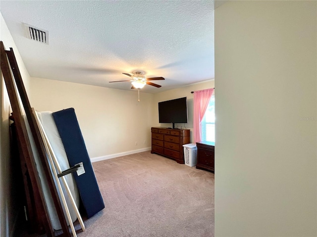 unfurnished bedroom featuring a textured ceiling, ceiling fan, and carpet floors