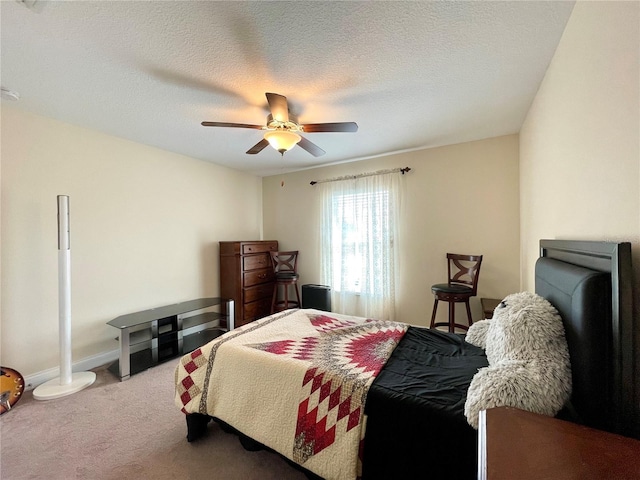 bedroom featuring a textured ceiling, carpet, and ceiling fan