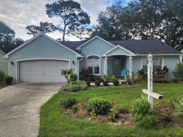 single story home featuring a garage and a front yard