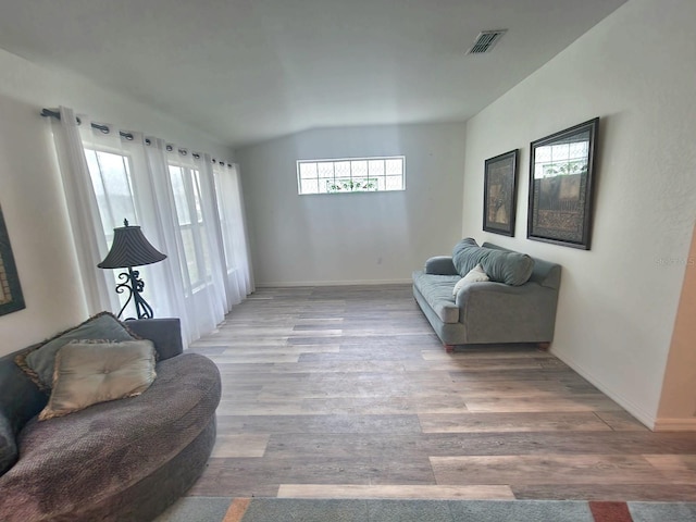 living room with lofted ceiling and light hardwood / wood-style floors