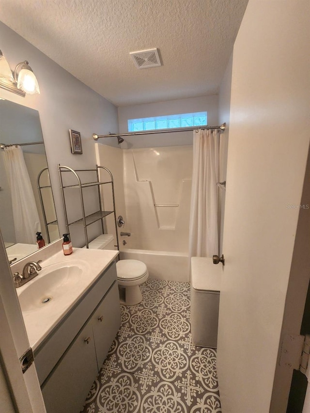 full bathroom with a textured ceiling, vanity, toilet, and shower / bath combo with shower curtain