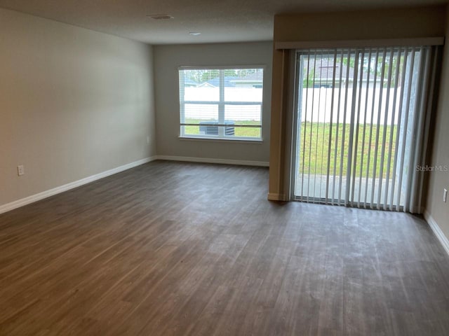 unfurnished room with dark hardwood / wood-style floors