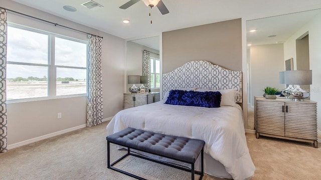 bedroom featuring light carpet, baseboards, visible vents, and a ceiling fan