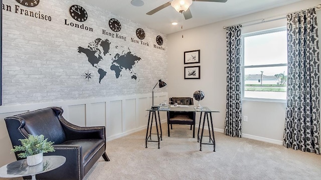 home office with ceiling fan, brick wall, wainscoting, and carpet flooring