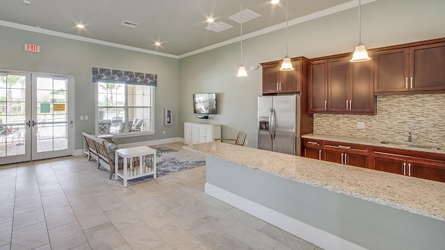 kitchen with stainless steel fridge with ice dispenser, ornamental molding, a sink, pendant lighting, and backsplash