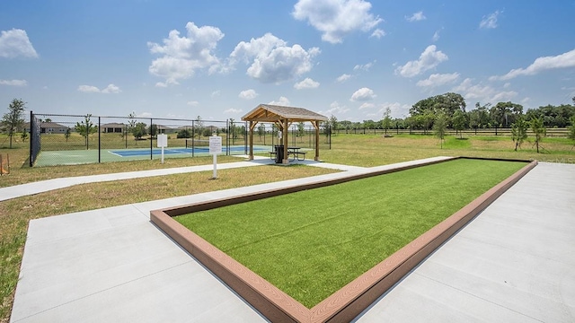 view of property's community with tennis court, a yard, and a gazebo