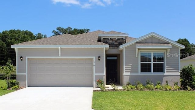 view of front of property with a garage and a front yard