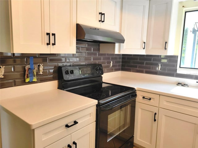 kitchen featuring white cabinets, sink, electric range, and backsplash