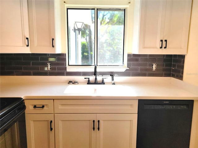 kitchen featuring backsplash, black appliances, and white cabinets