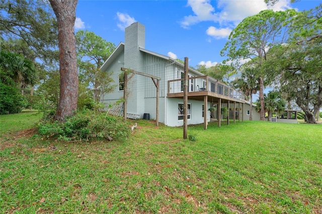 back of property with a lawn and a chimney