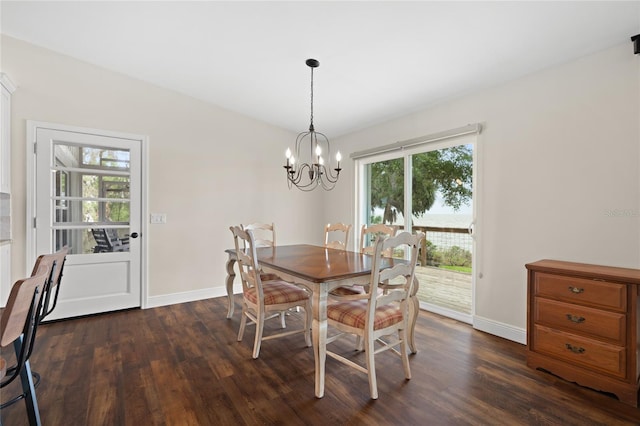 dining area with baseboards, dark wood-type flooring, and an inviting chandelier