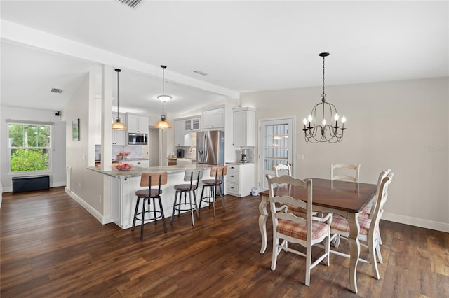 dining area featuring dark wood finished floors, a notable chandelier, lofted ceiling with beams, and baseboards