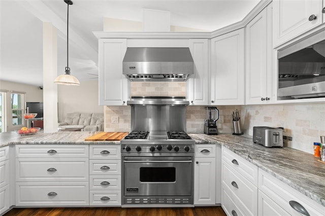 kitchen featuring ventilation hood, stainless steel appliances, decorative backsplash, and white cabinetry