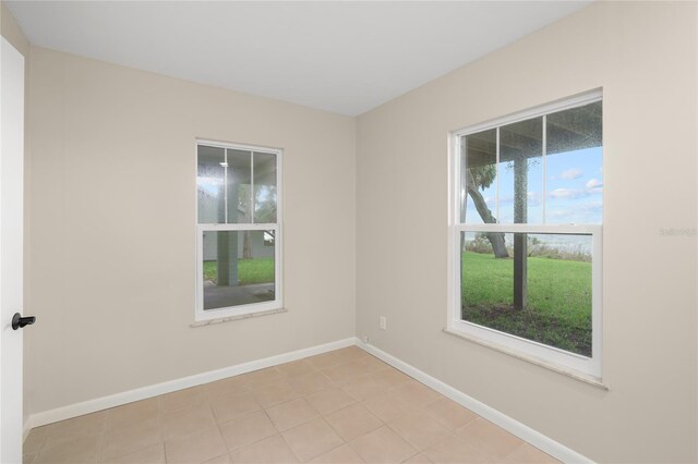 unfurnished room featuring baseboards