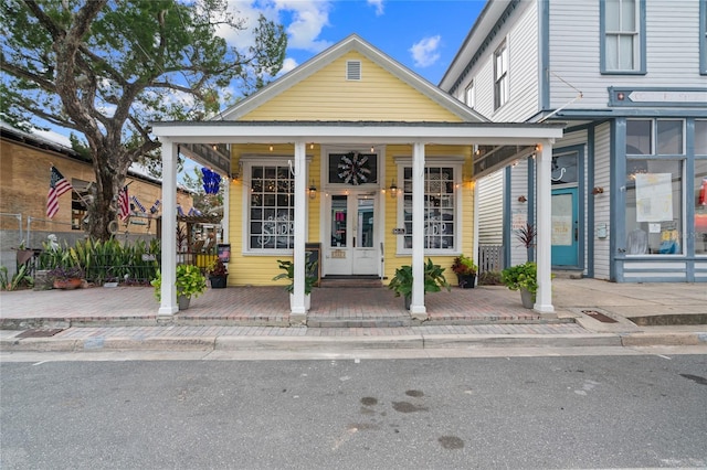 view of front of house with french doors and covered porch