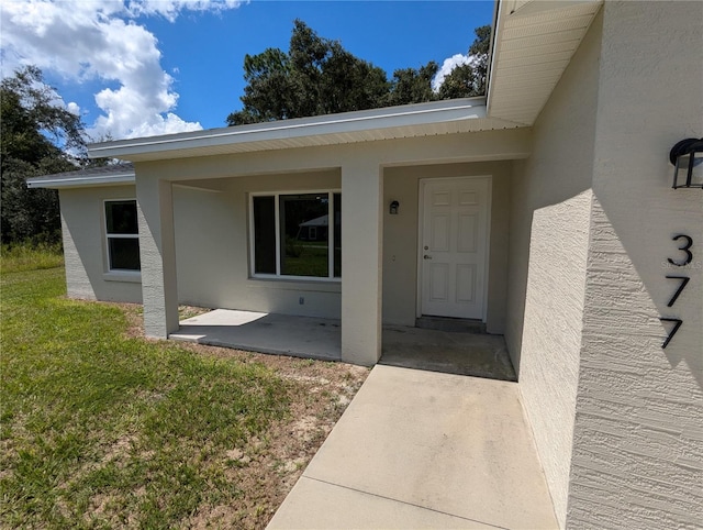 entrance to property with a yard