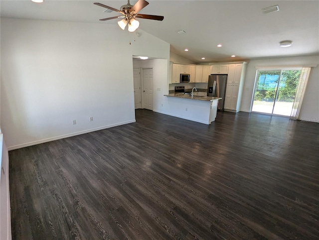 unfurnished living room with lofted ceiling, ceiling fan, dark hardwood / wood-style flooring, and sink