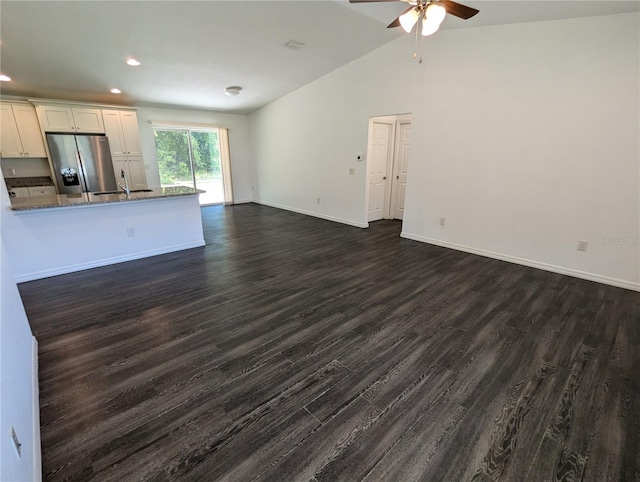 unfurnished living room with lofted ceiling, ceiling fan, dark hardwood / wood-style flooring, and sink