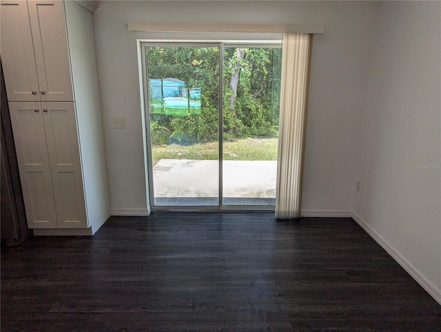 spare room featuring dark hardwood / wood-style floors