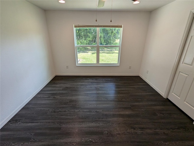 unfurnished room featuring ceiling fan and dark hardwood / wood-style flooring